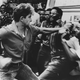 A pro-apartheid supporter attacks black South Africans during a rally in 1989.